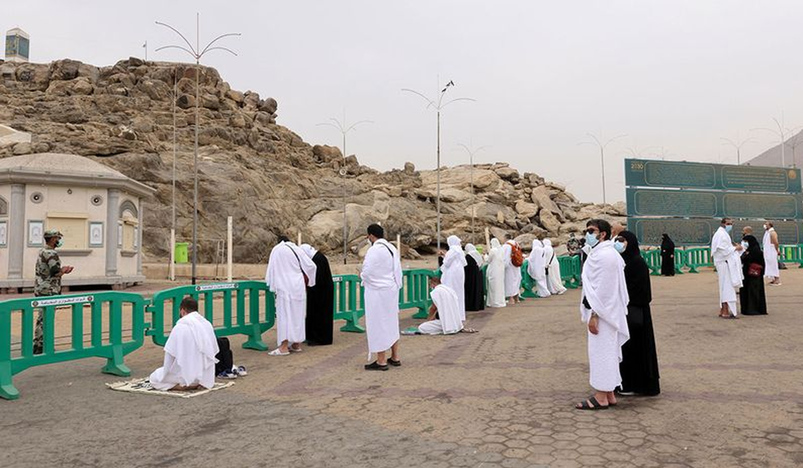 Masked haj pilgrims on Mount Arafat pray for COVID free world